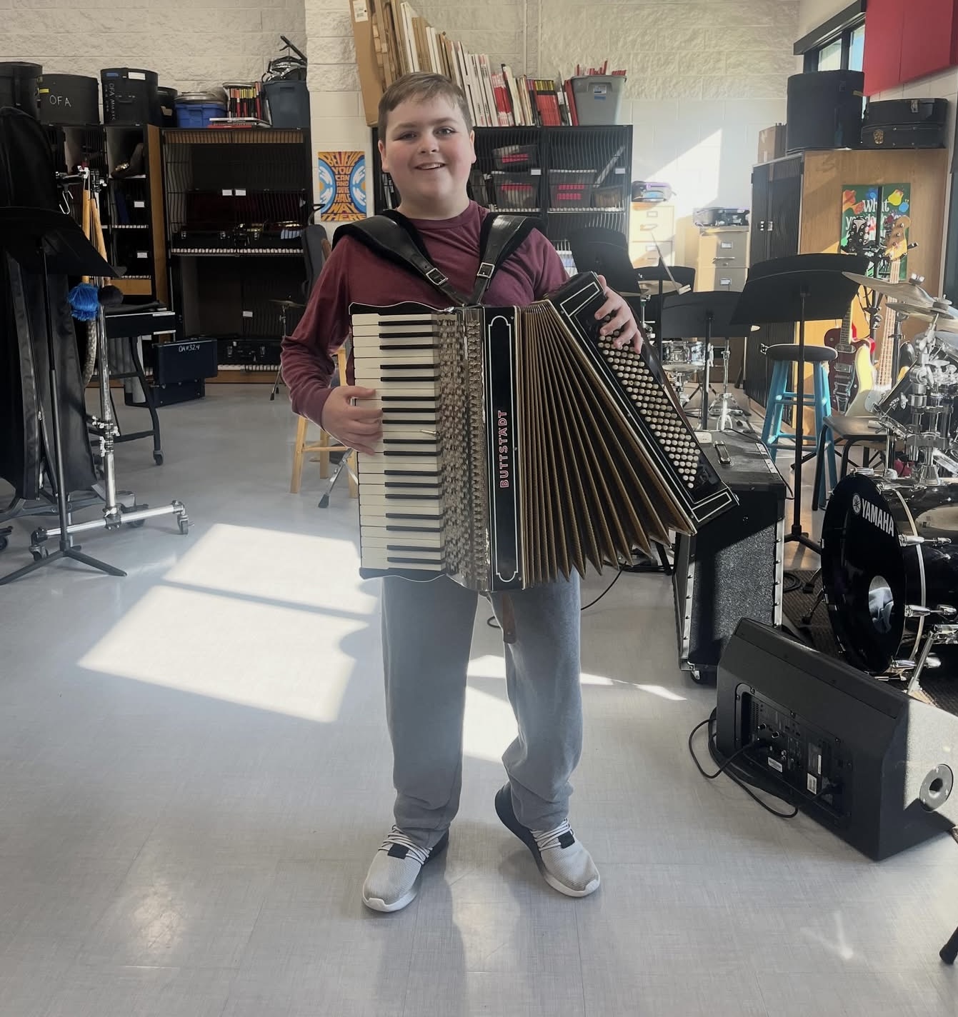 Brahm standing with his Buttstadt accordion in the band room